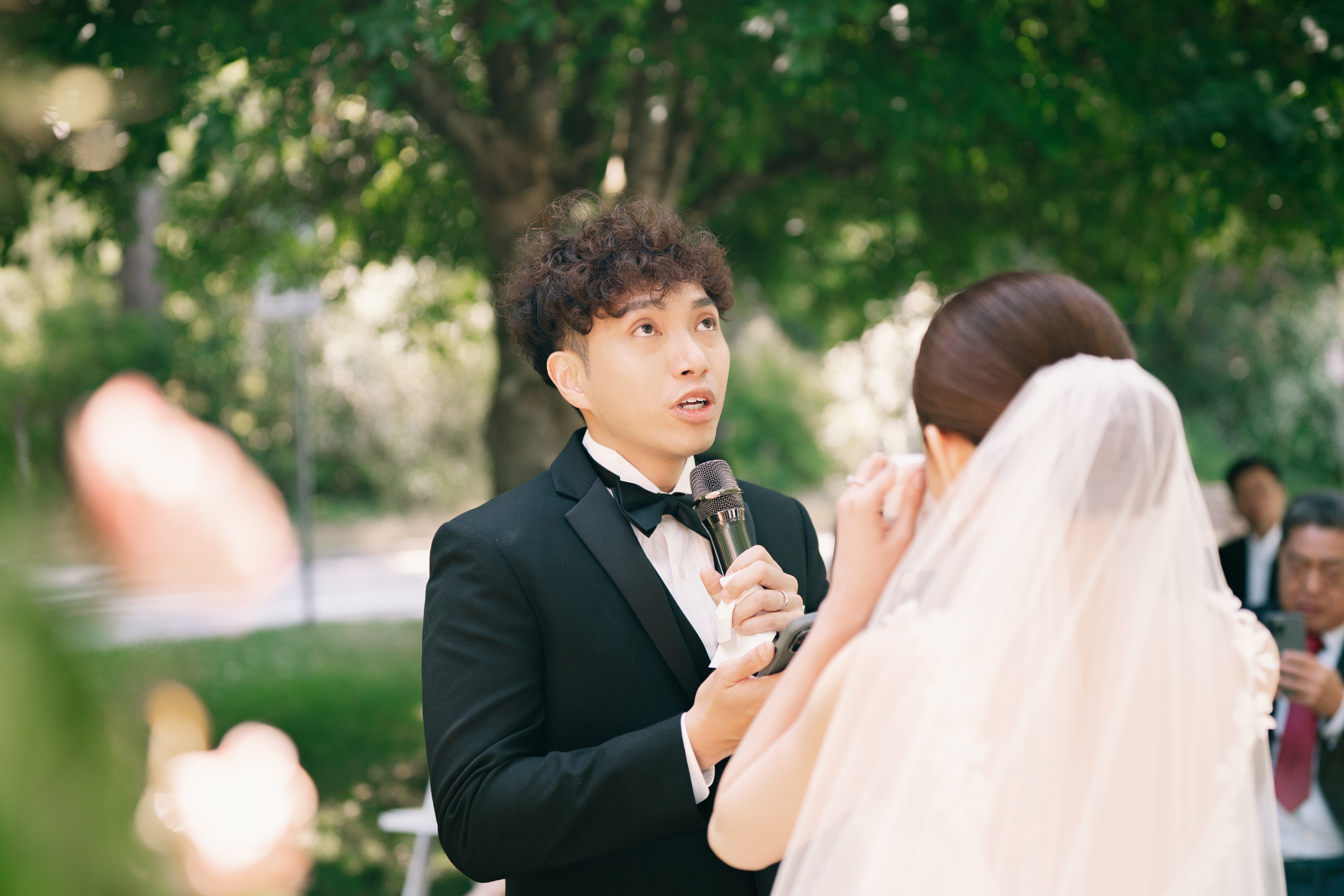 Bride and groom smiling during their garden wedding ceremony